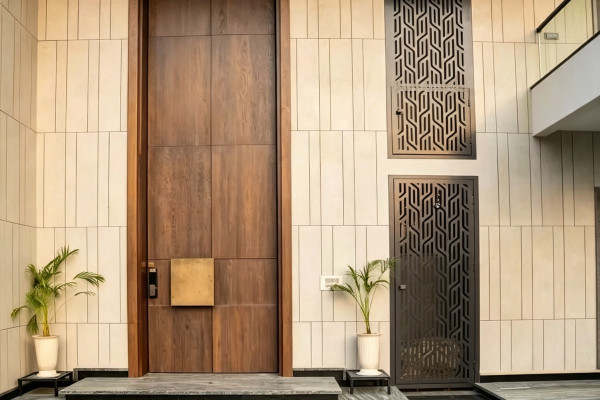 Custom extra-tall aluminum pivot doors on a villa facade